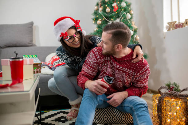 istock Happy couple decorating christmas tree 1287026892