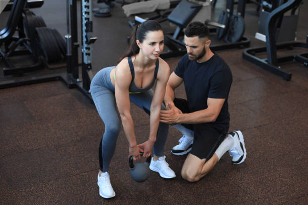 istock Fitness instructor exercising with his client at the gym. 1287027134