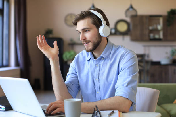 istock Confident man wearing headset speaking and watching business webinar training, listening to lecture. 1287028445