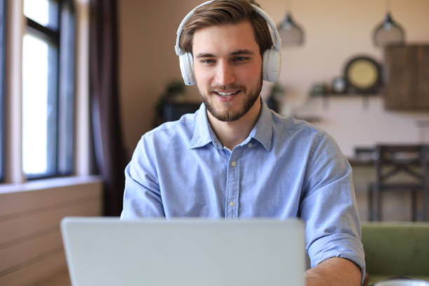 istock Confident man wearing headset speaking and watching business webinar training, listening to lecture. 1287028477