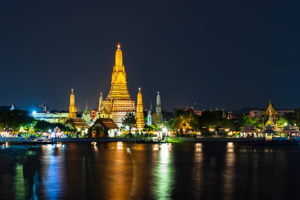 istock Wat Arun with Chao Phraya river at night in Bangkok, Thailand 1287028499