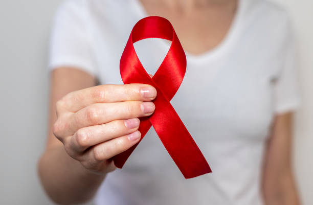 istock Red ribbon for aids world day support, close up 1287030043