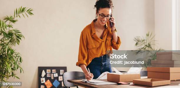 Drop Shipping Business Owner Confirming The Order On Phone Stock Photo - Download Image Now