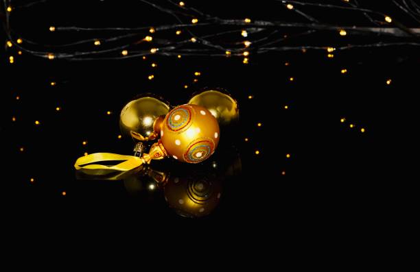istock Golden Christmas balls on black background 1287030482