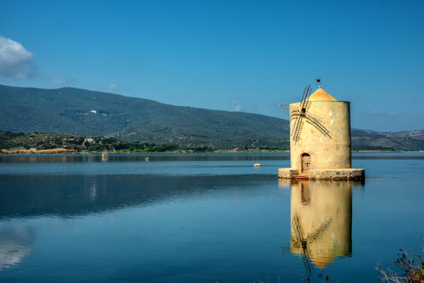 old spanish windmill in orbetello lagoon, argentario, italy - clear sky italy tuscany image imagens e fotografias de stock