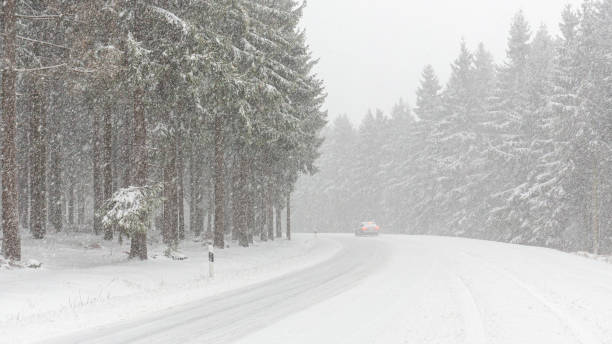 istock snow covered mountain road in winter storm 1287032717