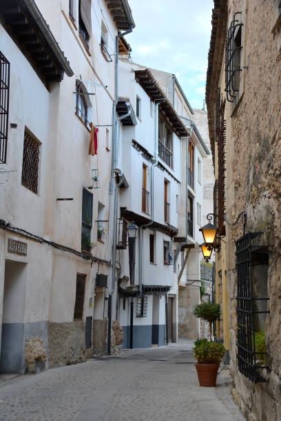 istock Narrow street with illuminated street light, Cuenca 1287033116