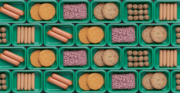 pattern of green trays with vegetarian meat substitute products, plant based mock meat