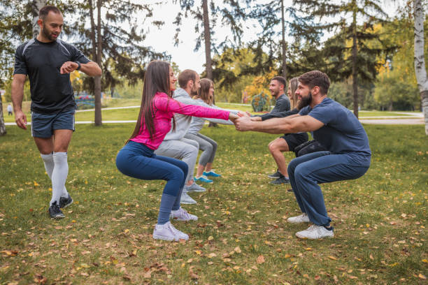istock Pairs cooperating while exercising on a sports training 1287034124