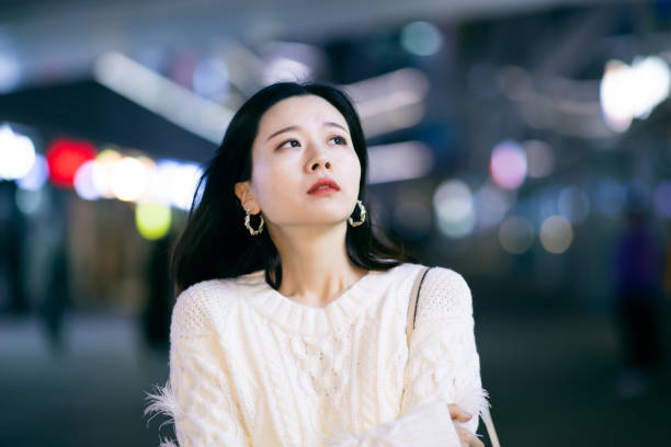 istock Sad woman in city night 1287034914