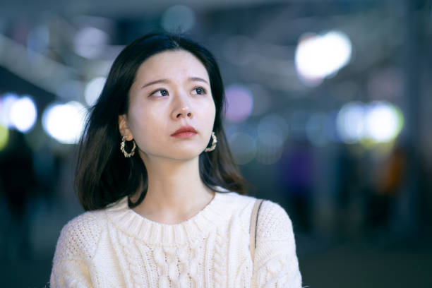 istock Sad woman in city night 1287034923