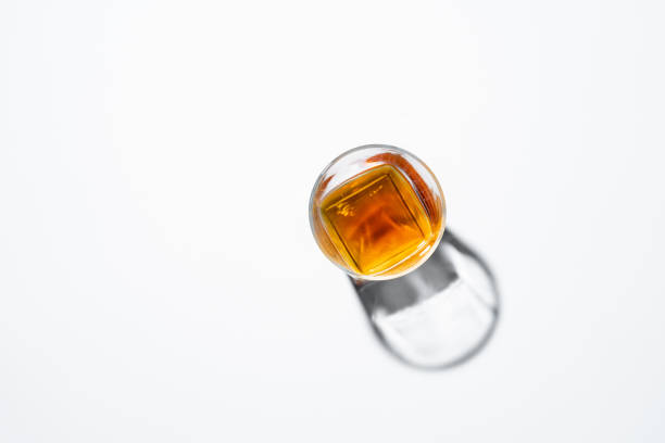 Top view of glass whiskey on white background Top view of glass whiskey on white background cognac brandy stock pictures, royalty-free photos & images