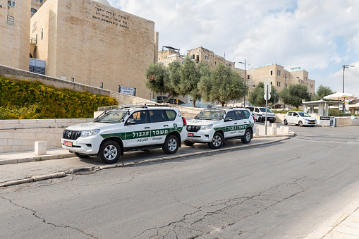 Jerusalem, Israel, November 14, 2020 : Border police cars are parked in the square near the Dung Gate, in front of the walls of the Temple Mount in the Old city of Jerusalem in Israel