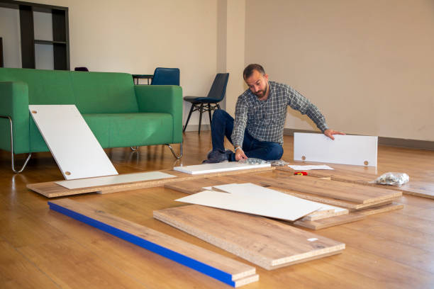 istock Man surrounded by unassembled furniture 1287036190