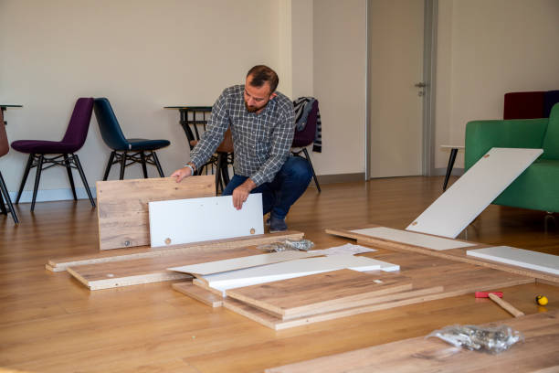 istock Man surrounded by unassembled furniture 1287036292