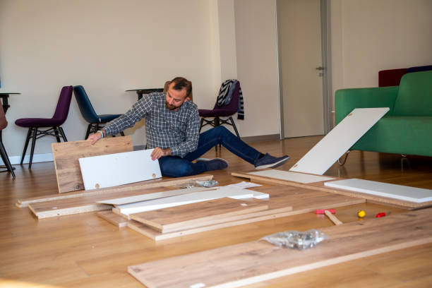 istock Man surrounded by unassembled furniture 1287036362