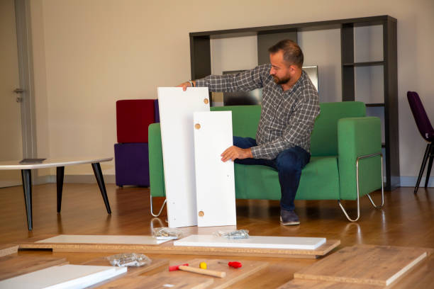 istock Man surrounded by unassembled furniture 1287036411