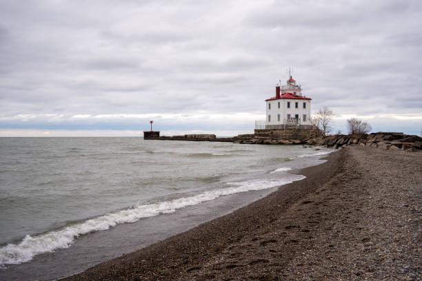 Fairport Harbor West Lighthouse along beach stock photo