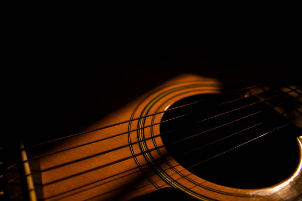 istock Sun rays light up an acoustic guitar 1287039060