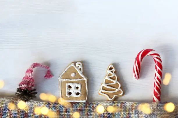 gnome in a hat, gingerbread house, ginger tree and striped candy