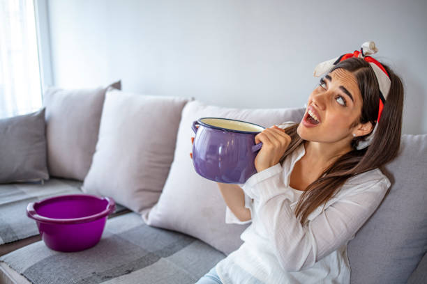 istock Upset household calling roof repair service while water leaking from ceiling. 1287042398