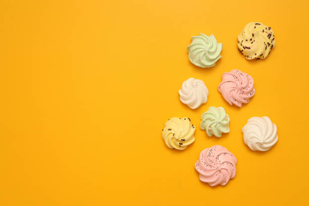 istock Brignt macarons for sweet break on yellow background top view pattern 1287042522
