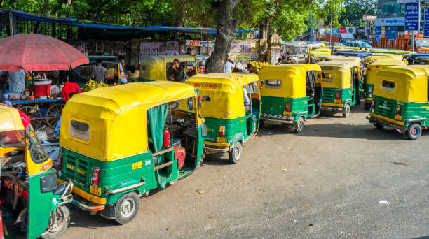 Tuk Tuks in the streets of New Delhi, India New Delhi / India - September 2019: Tuk Tuks in the streets of New Delhi, India auto rickshaw taxi india stock pictures, royalty-free photos & images