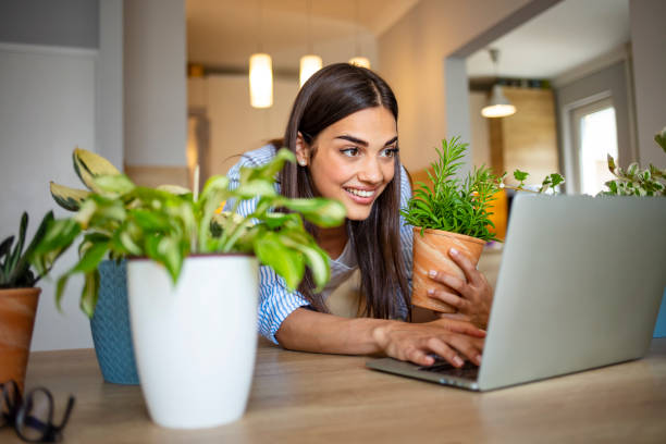 istock Beautiful young woman caring for her plants. 1287042984