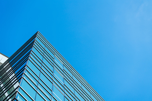 underside panoramic and perspective view to steel blue glass high rise building skyscrapers, business concept of successful industrial architecture