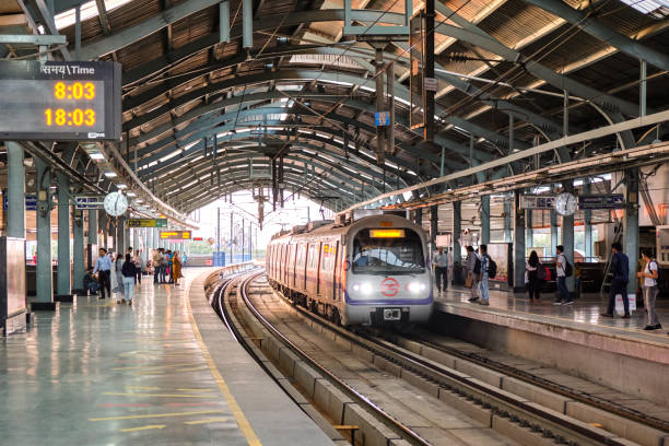 Train arrives at metro station of Delhi Metro system New Delhi / India - September 19, 2019: Train arrives at metro station of Delhi Metro system delhi metro stock pictures, royalty-free photos & images