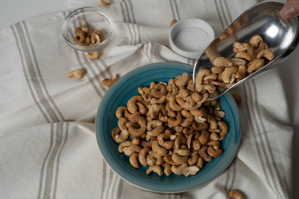 istock roasted cashew nuts 
in a round blue plate on white background 1287044398