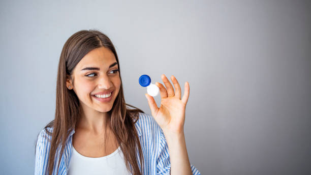 istock Happy Woman Holding Contact Lenses Case. 1287045412