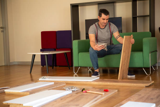 istock Man surrounded by unassembled furniture 1287045764