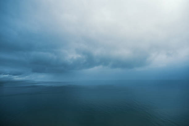 Fluffy clouds in the blue sky over sea