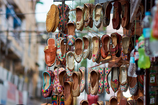 Traditional Indian shoes at Bapu Bazar in Jaipur, India. Bapu Bazar in Jaipur is one of the most famous markets of the city for buying traditional Indian shoes and Jutis, Rajasthan, India