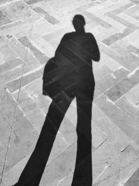 istock Women standing human being shadow lady 1287047501