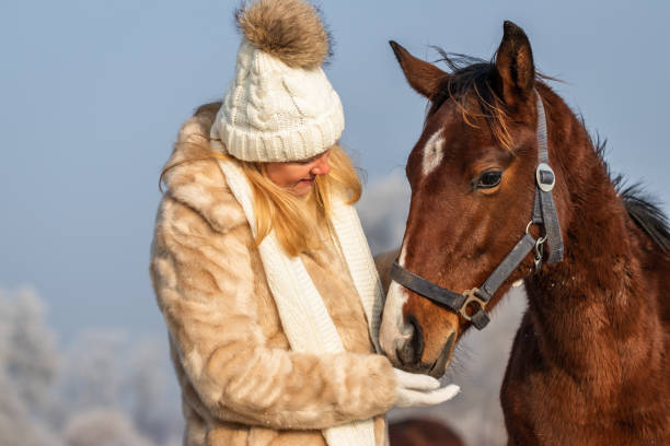 woman with horse in the snow
