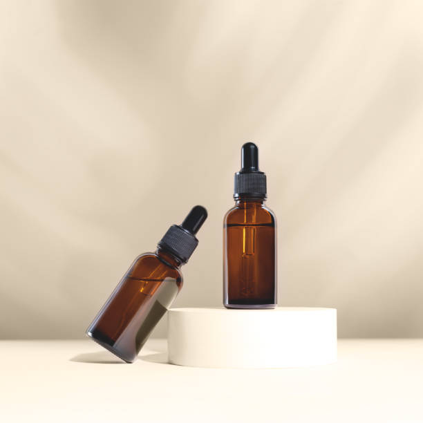 istock Glass dropper bottles on the white marble background. 1287048814