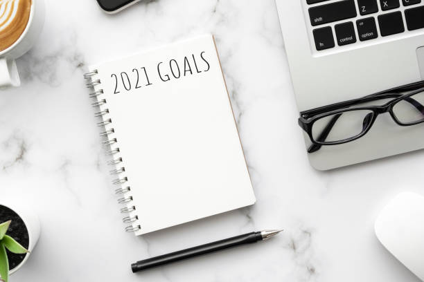 istock Note book with 2021 goals text on it to apply new year resolutions and plan. 1287049057