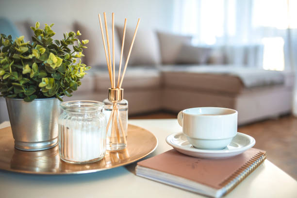 Scandinavian home decor candles, fragrance, books Candle and aromatic reed freshener on table in spa salon. aroma liquid in glass bottle with reed sticks. aroma Diffuser In Luxury in bedroom. Hygge. Scandinavian home decor candles, fragrance, books home diffuser stock pictures, royalty-free photos & images