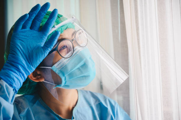 istock Nurse having tired from work while wearing PPE suit for protect coronavirus disease. 1287051005