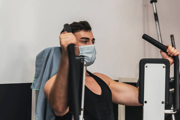 istock boy with mask doing chest exercise in gym 1287052442