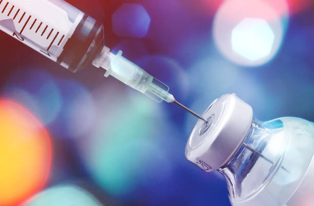 istock Covid-19 Coronavirus Pandemic Vaccination Test with Mini Bottle and Syringe 1287053349