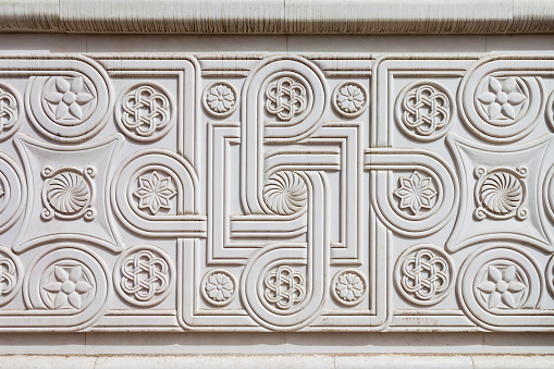 Traditional balkan pattern design background on Porta Macedonia triumphal arch in Skopje city, North Macedonia