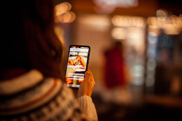 istock Close up hand holding mobile phone with order food online 1287053909