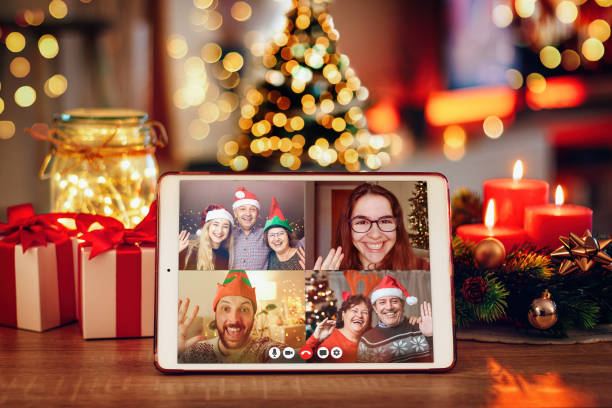 Christmas video call with the family. Concept of families in quarantine during Christmas because of the coronavirus Christmas video call with the family. Concept of families in quarantine during Christmas because of the coronavirus. Xmas still life with a tablet in a cozy room virtual event photos stock pictures, royalty-free photos & images
