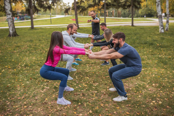 istock Happy people exercising in the park 1287057574