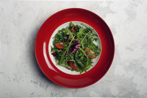 istock Arugula, tomato, olive oil salad. 1287057631