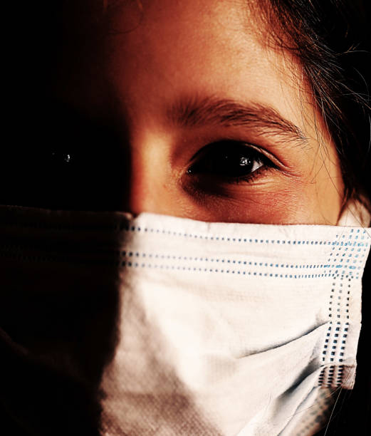 istock girl with surgical mask with a very dramatic effect 1287058232