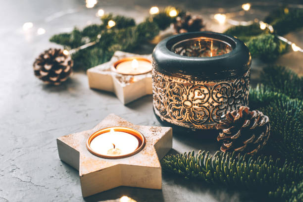 istock Christmas composition of candlesticks, fir branches and garland. 1287060048